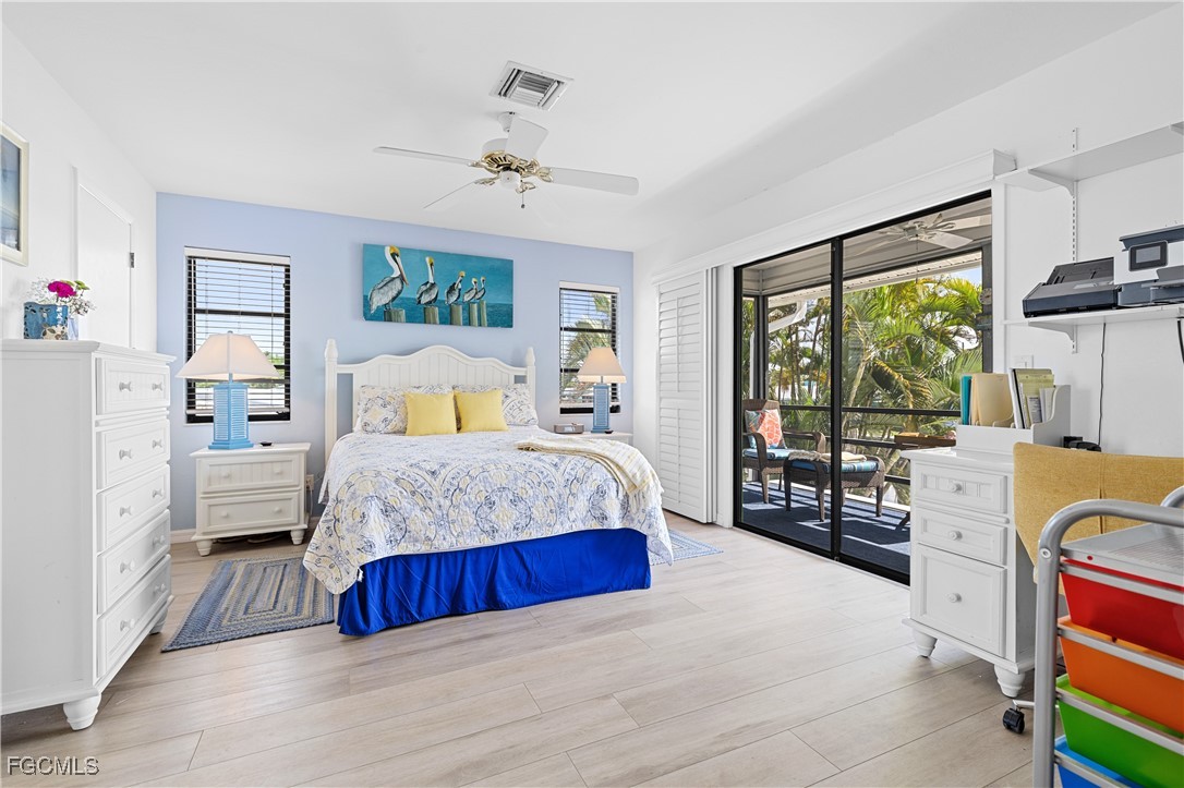 2831 Janet Street Matlacha, FL 33993 - Photo 16 of 43 a bedroom with a bed and wooden floor