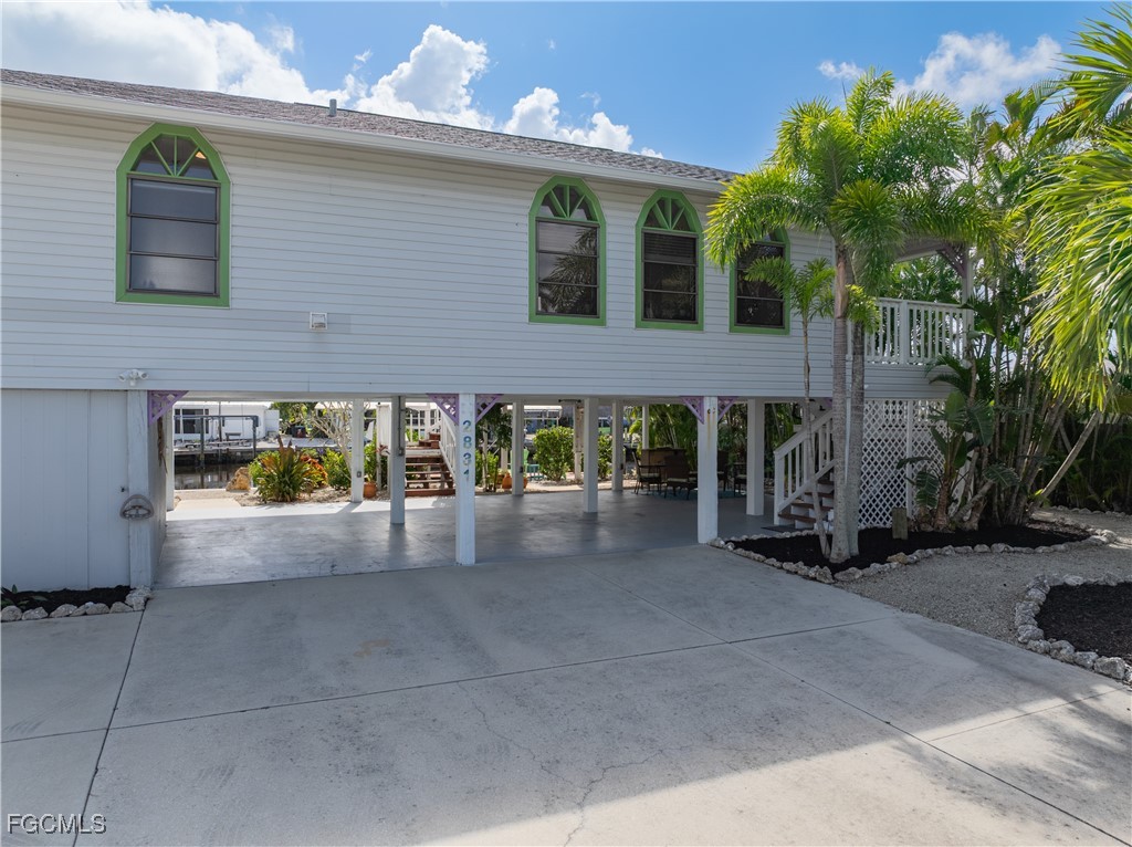 2831 Janet Street Matlacha, FL 33993 - Photo 2 of 43 a view of a patio with dining table and chairs under an umbrella
