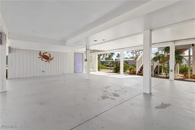 a view of a house with a floor to ceiling window and potted plants