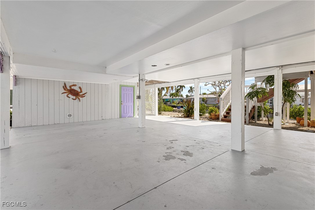 2831 Janet Street Matlacha, FL 33993 - Photo 24 of 43 a view of an empty room with wooden floor and windows