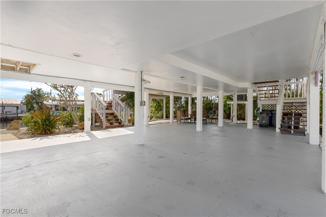 2831 Janet Street Matlacha, FL 33993 - Photo 25 of 43 a view of a house with a floor to ceiling window and potted plants