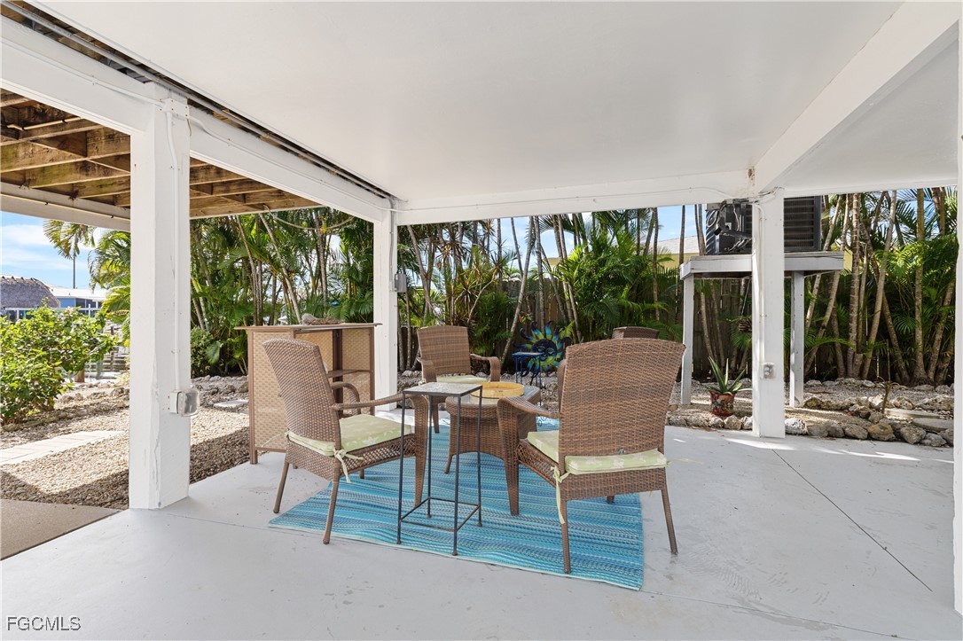 2831 Janet Street Matlacha, FL 33993 - Photo 26 of 43 a view of a patio with a dining table and chairs