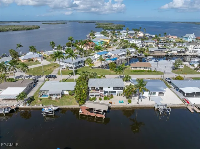 an aerial view of a house with a lake view