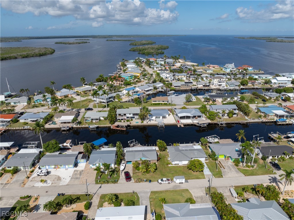 2831 Janet Street Matlacha, FL 33993 - Photo 39 of 43 a view of a water fountain and a couple of cars parked in a yard