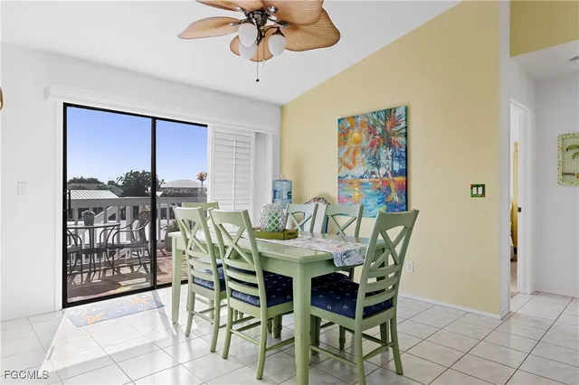 a dining room with wooden floor a glass table and chairs