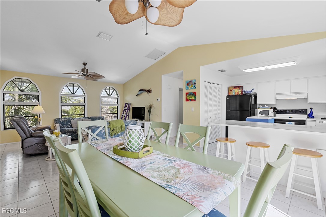 2831 Janet Street Matlacha, FL 33993 - Photo 10 of 43 a dining room with wooden floor a glass table and chairs