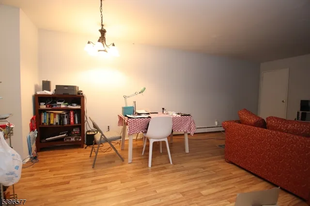 a living room with furniture a piano and a bookshelf