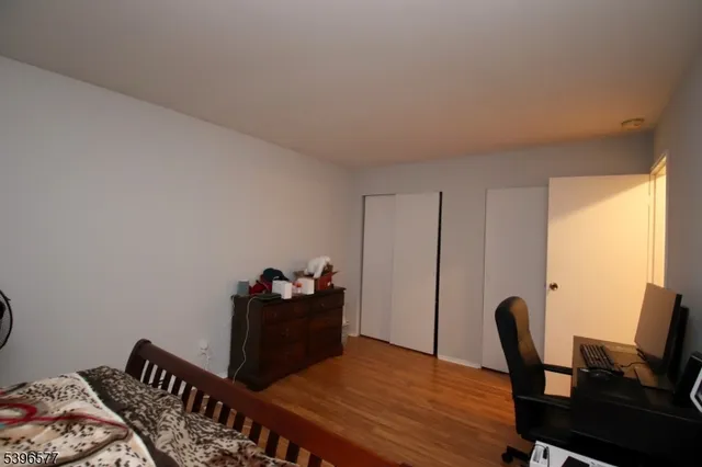 a bedroom with a bed and a desk