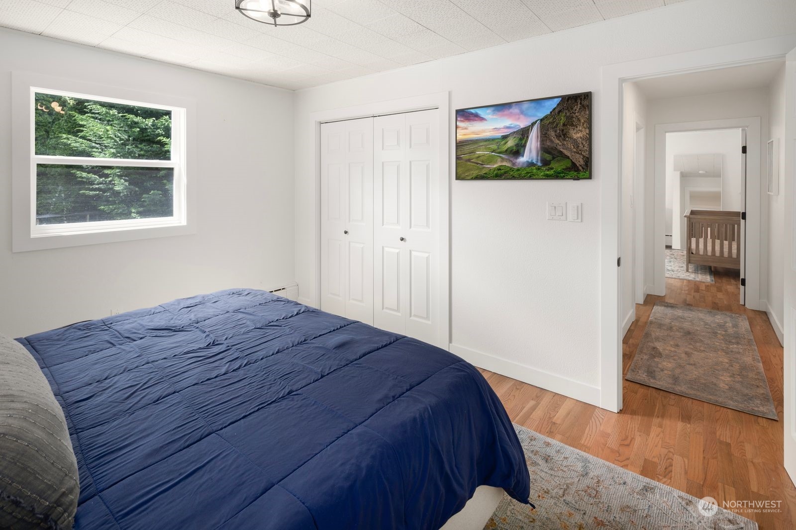1417 North 40th Street Renton, WA 98056 - Photo 14 of 33 a bedroom with a bed and a painting on the wall
