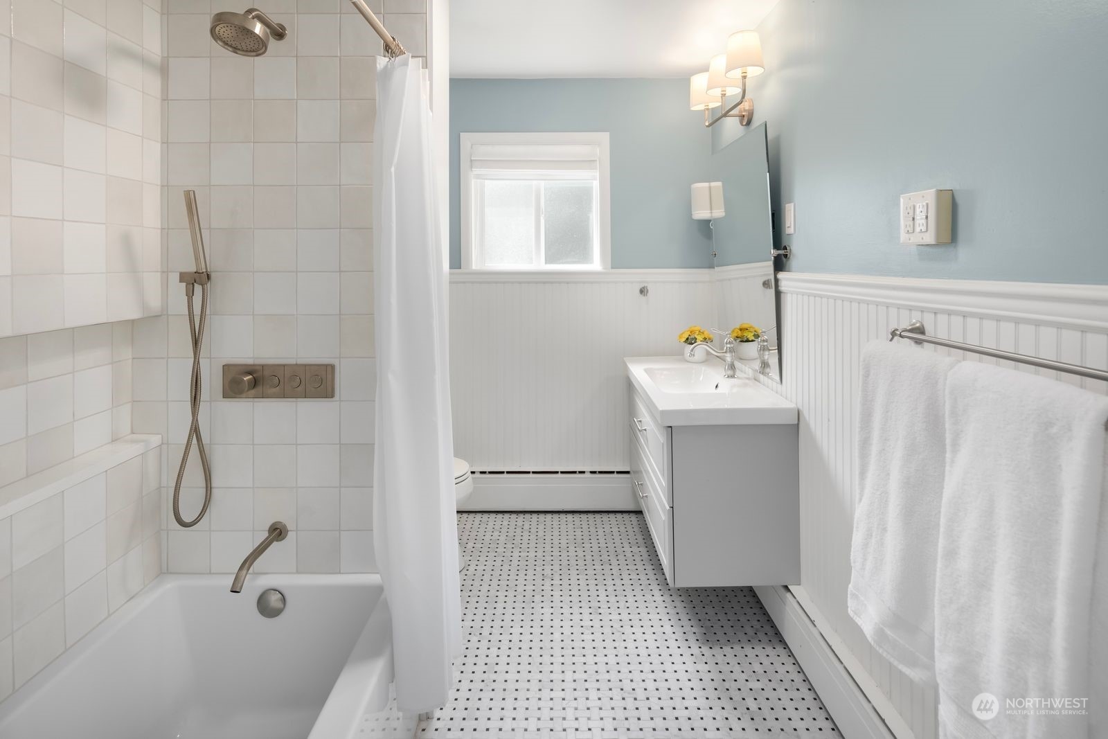 1417 North 40th Street Renton, WA 98056 - Photo 15 of 33 a bathroom with a sink a vanity and shower