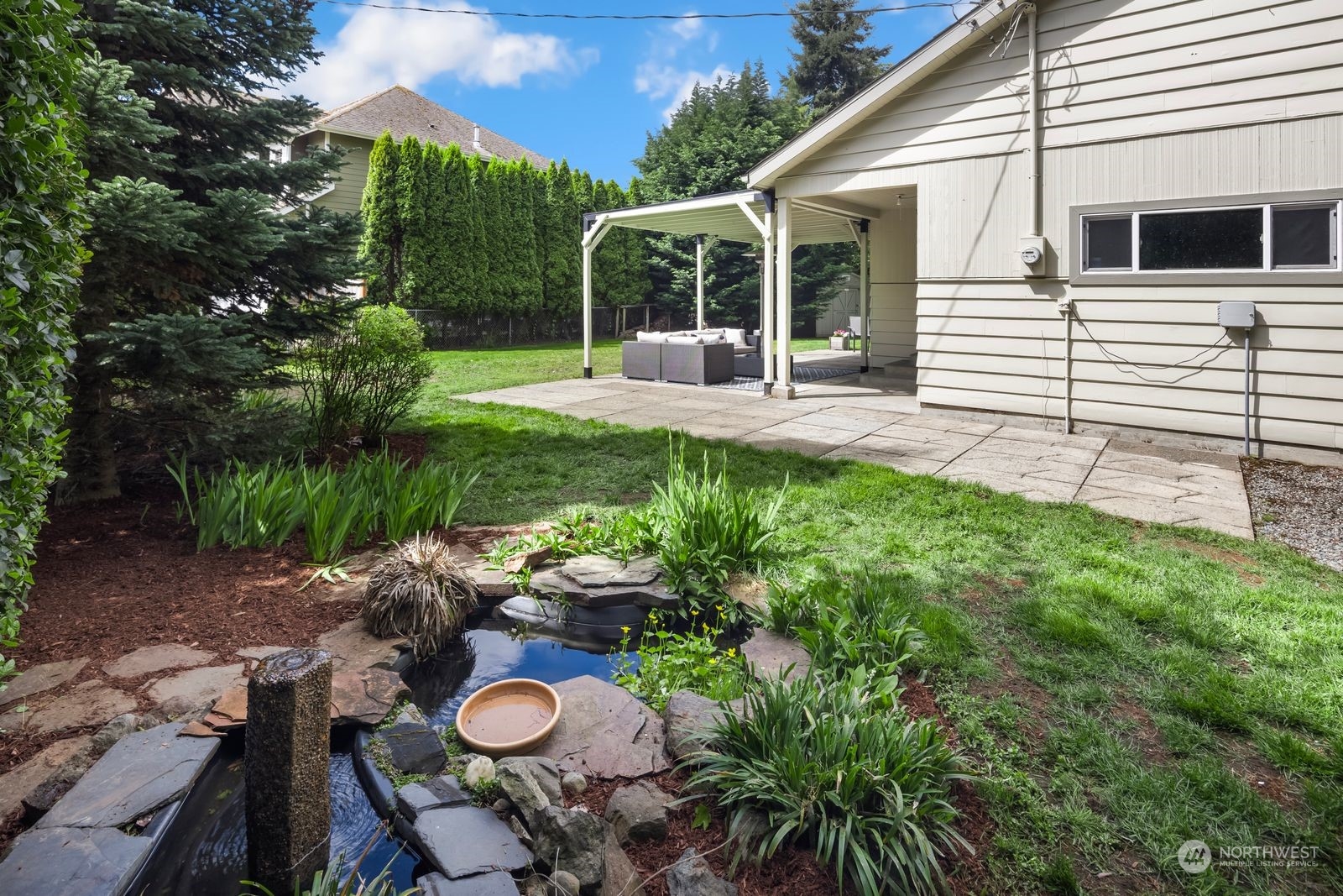 1417 North 40th Street Renton, WA 98056 - Photo 27 of 33 a view of a chair and table in backyard of the house