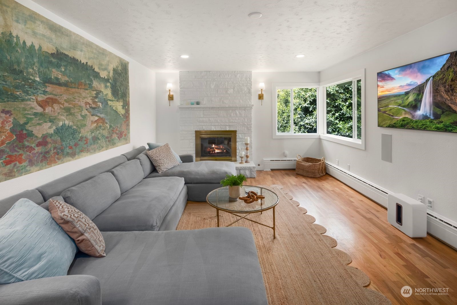 1417 North 40th Street Renton, WA 98056 - Photo 8 of 33 a living room with furniture a fireplace and a floor to ceiling window
