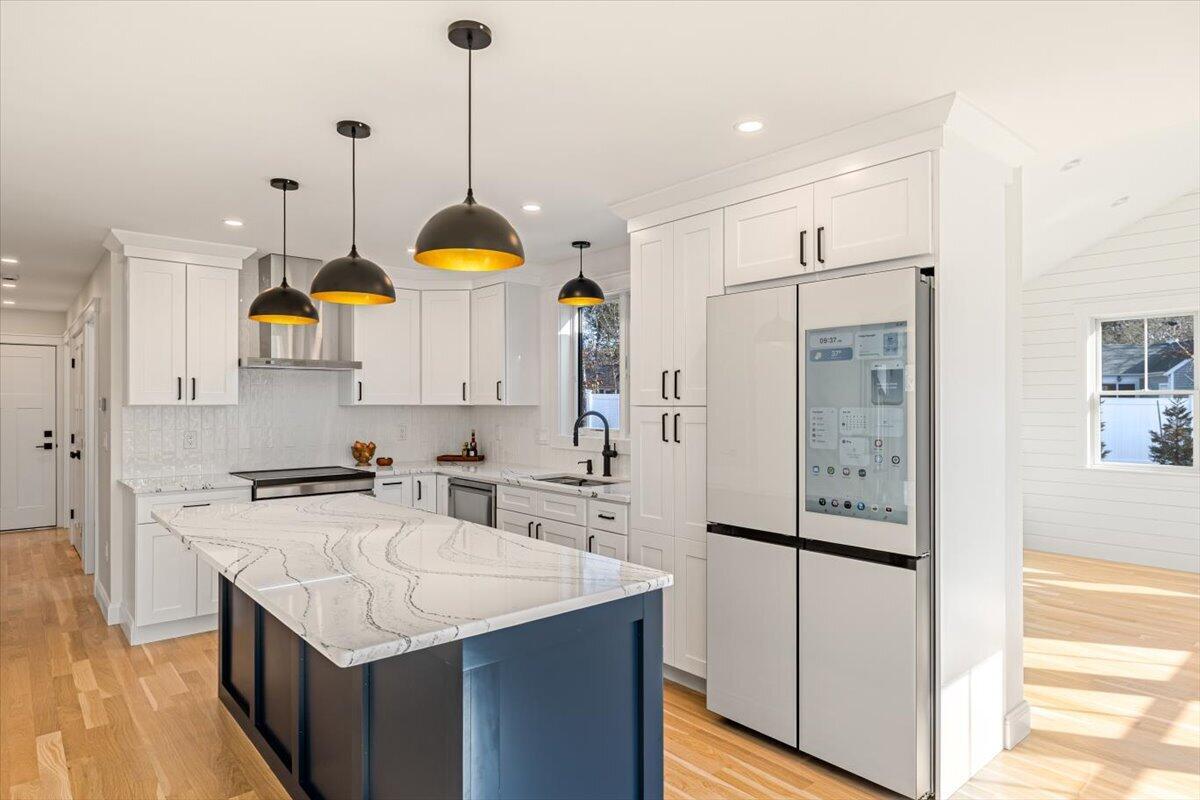 58 Old Chatham Road Brewster, MA 02631 - Photo 11 of 43 a kitchen with stainless steel appliances granite countertop a sink a stove and a refrigerator