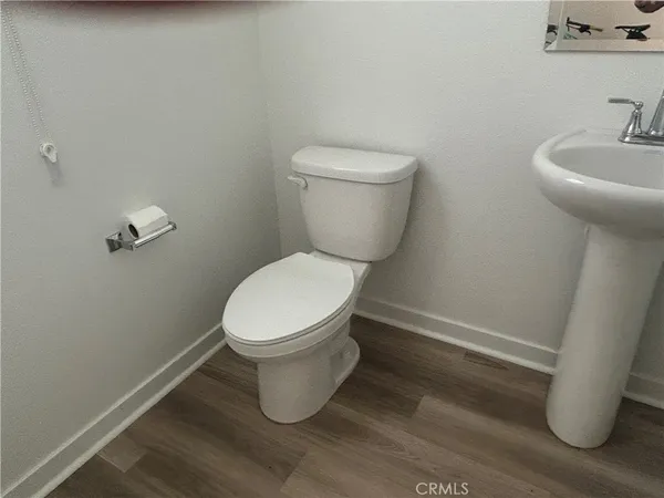 a white toilet sitting next to a bathroom sink