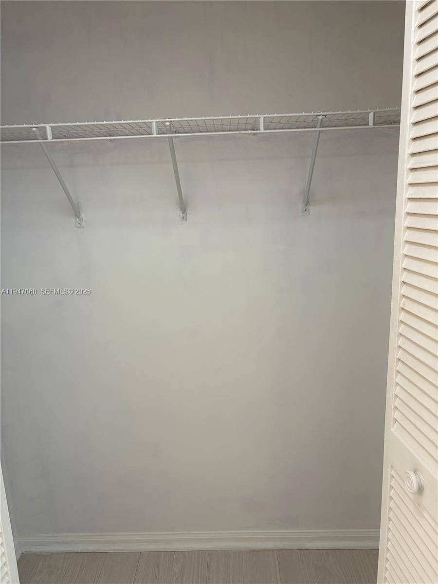 17365 Southwest 142nd Court Miami, FL 33177 - Photo 8 of 18 a view of a room with racks on the wall