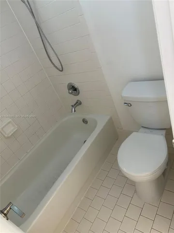 a bathroom with a toilet and a bathtub