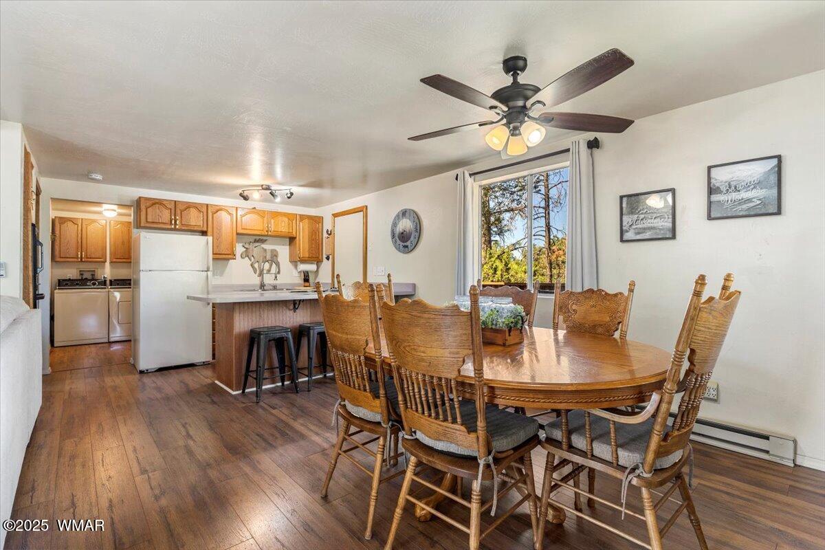 2001 Broken Arrow Road Overgaard, AZ 85933 - Photo 9 of 38 a view of a dining room with furniture and wooden floor