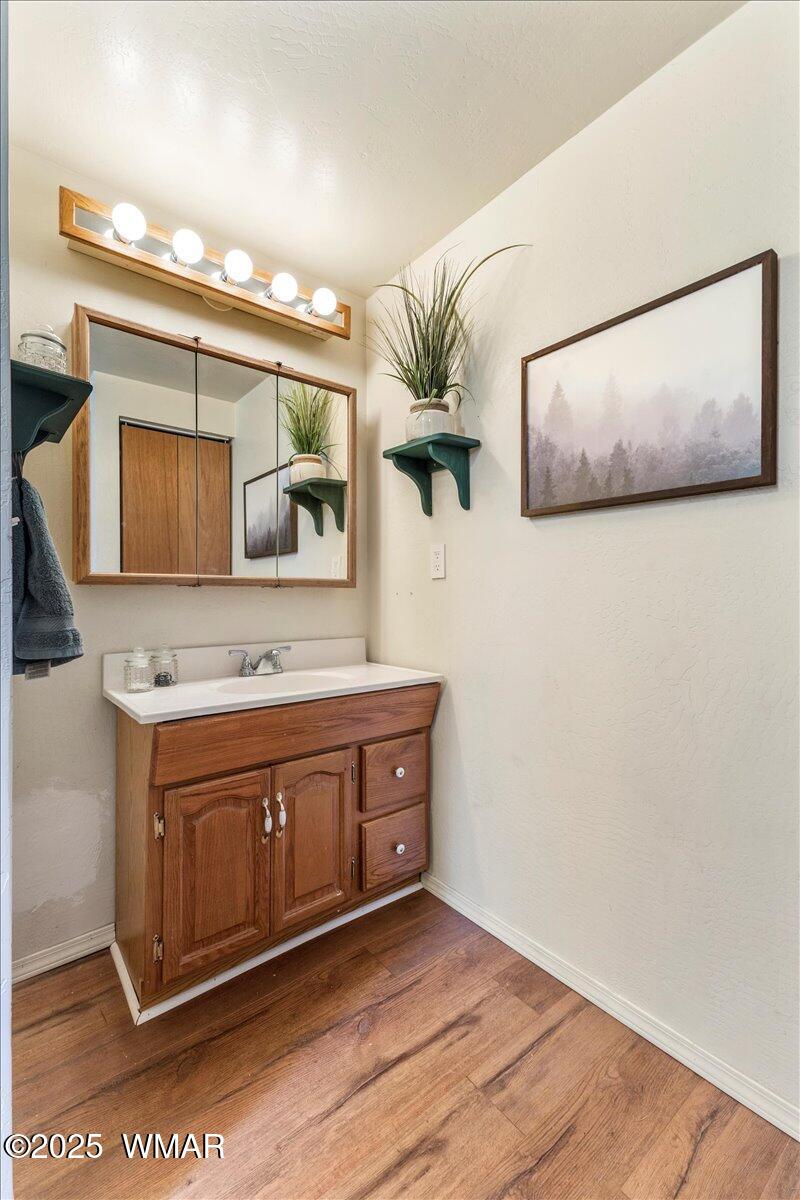 2001 Broken Arrow Road Overgaard, AZ 85933 - Photo 15 of 38 a view of a sink and cabinet with wooden floor