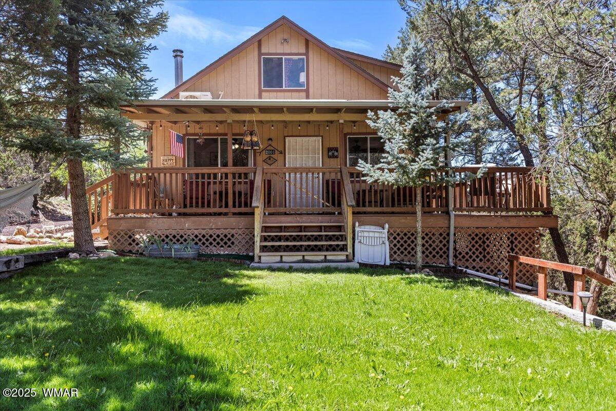 a view of a house with a small yard and wooden fence
