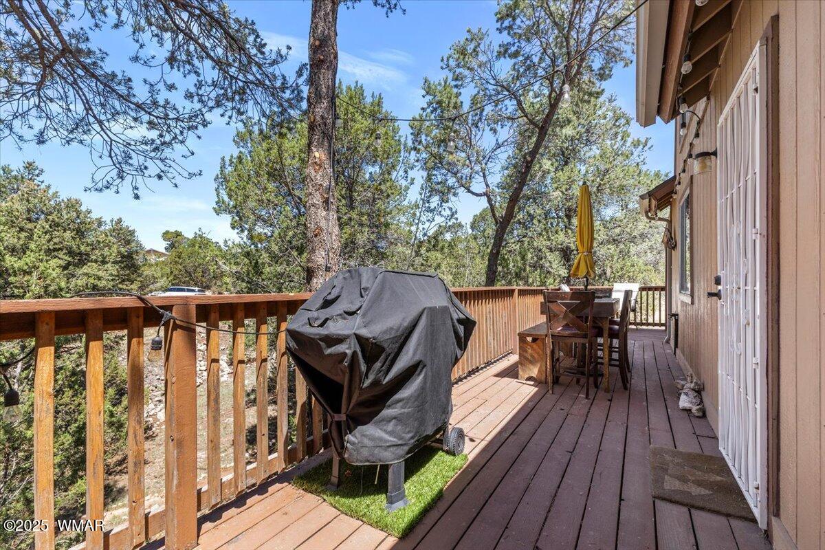 2001 Broken Arrow Road Overgaard, AZ 85933 - Photo 30 of 38 a view of deck with table and chairs and wooden floor