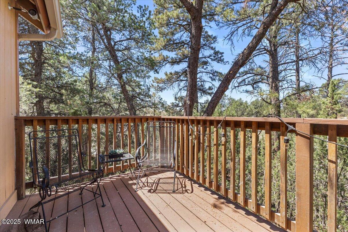 2001 Broken Arrow Road Overgaard, AZ 85933 - Photo 31 of 38 a view of balcony with wooden floor and fence