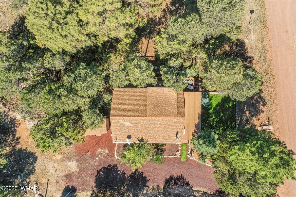2001 Broken Arrow Road Overgaard, AZ 85933 - Photo 32 of 38 an aerial view of a house with a yard and large trees
