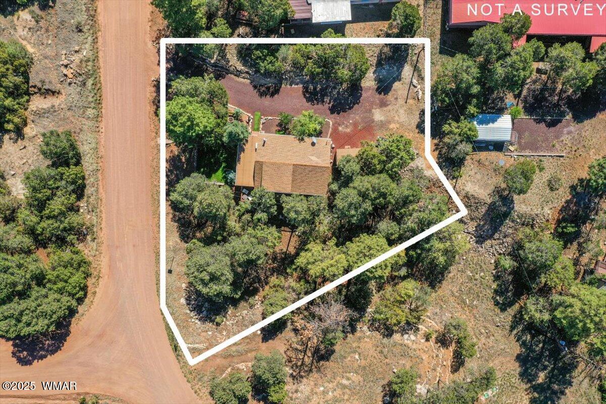 2001 Broken Arrow Road Overgaard, AZ 85933 - Photo 35 of 38 an aerial view of a house with a yard and garden