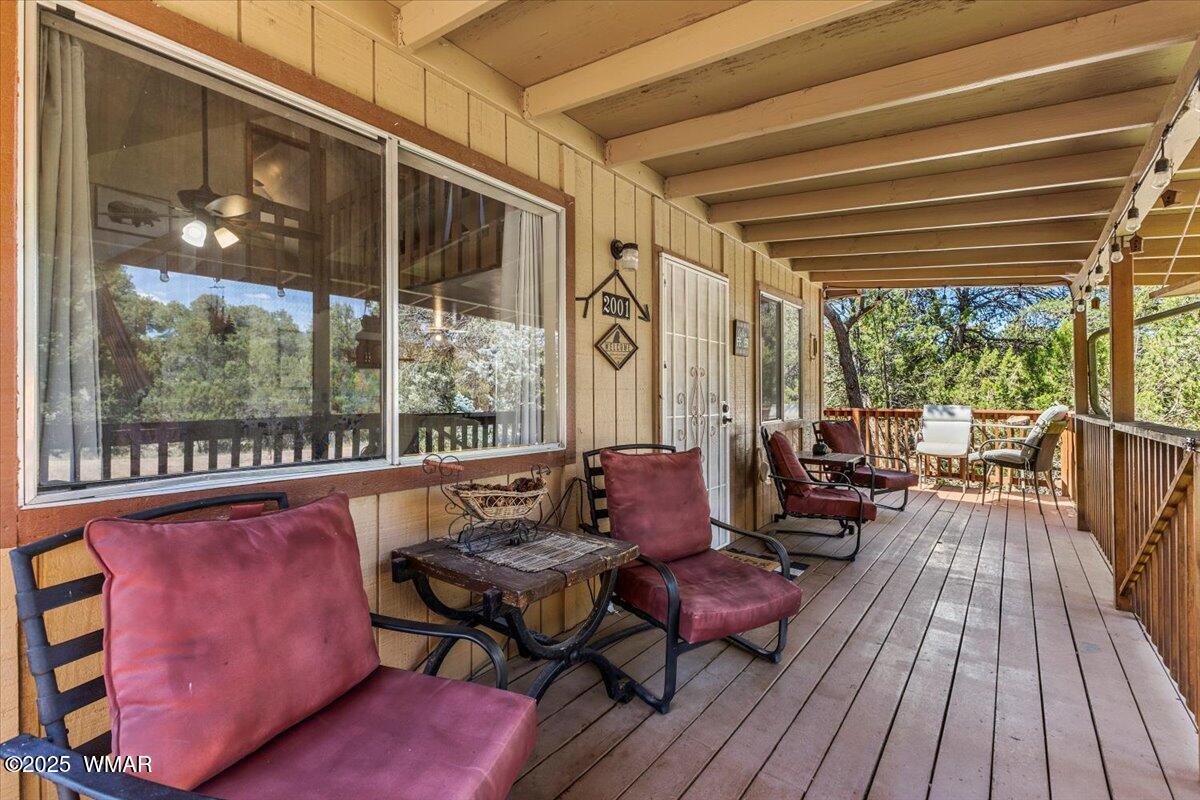 2001 Broken Arrow Road Overgaard, AZ 85933 - Photo 5 of 38 a outdoor living space with furniture and wooden floor