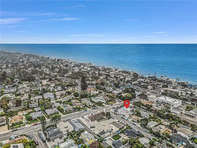 an aerial view of residential building and ocean