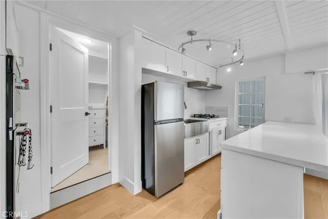 a kitchen with stainless steel appliances kitchen island a stove and a refrigerator