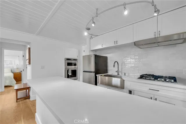 a large white room with a large window and furniture