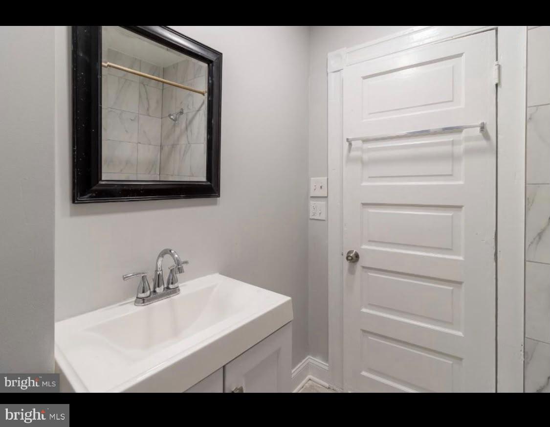 1626 Appleton Street Baltimore, MD 21217 - Photo 11 of 18 a bathroom with a sink and mirror