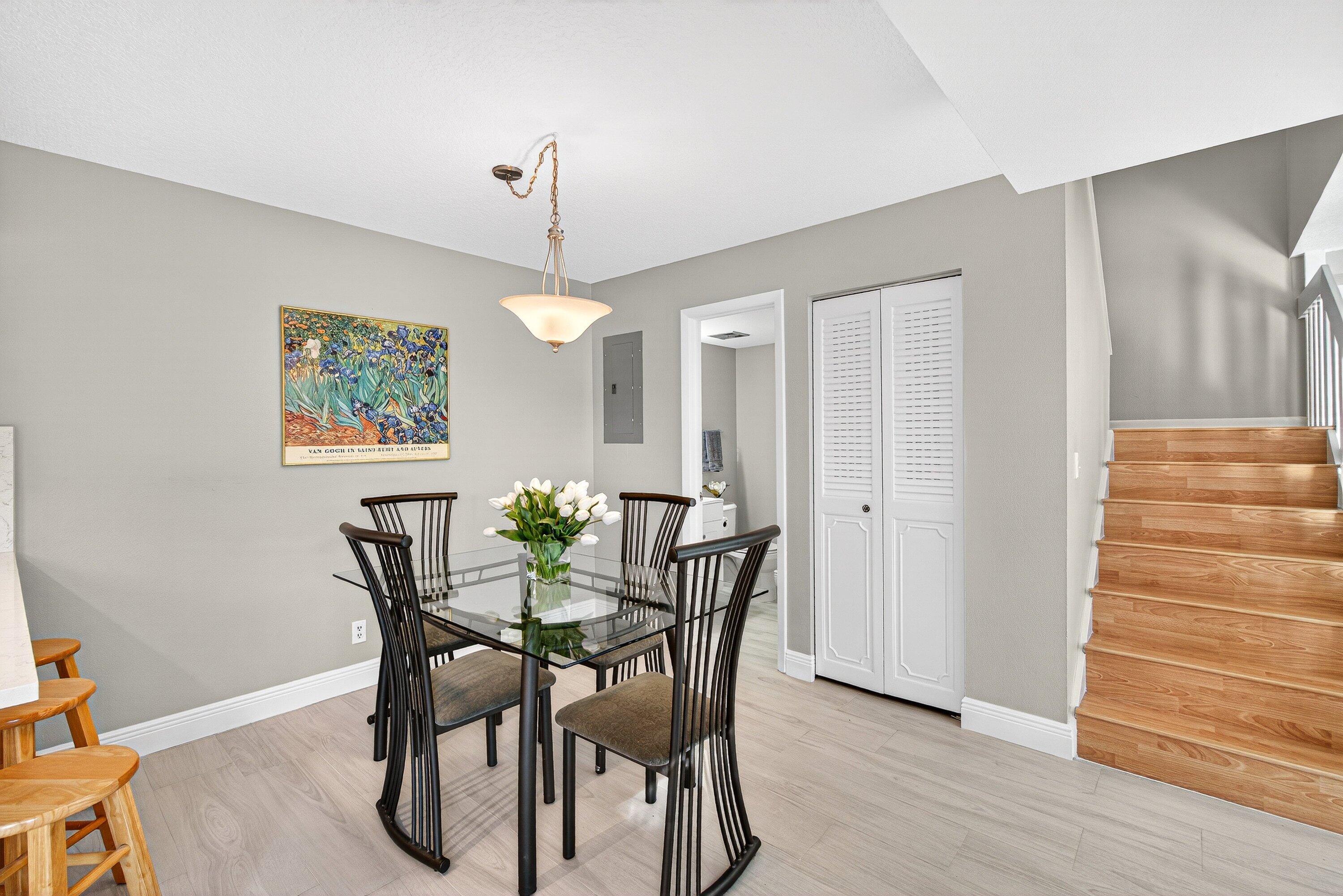 865 Northwest 29th Avenue, Unit D Delray Beach, FL 33445 - Photo 11 of 70 a view of a dining room with furniture and wooden floor