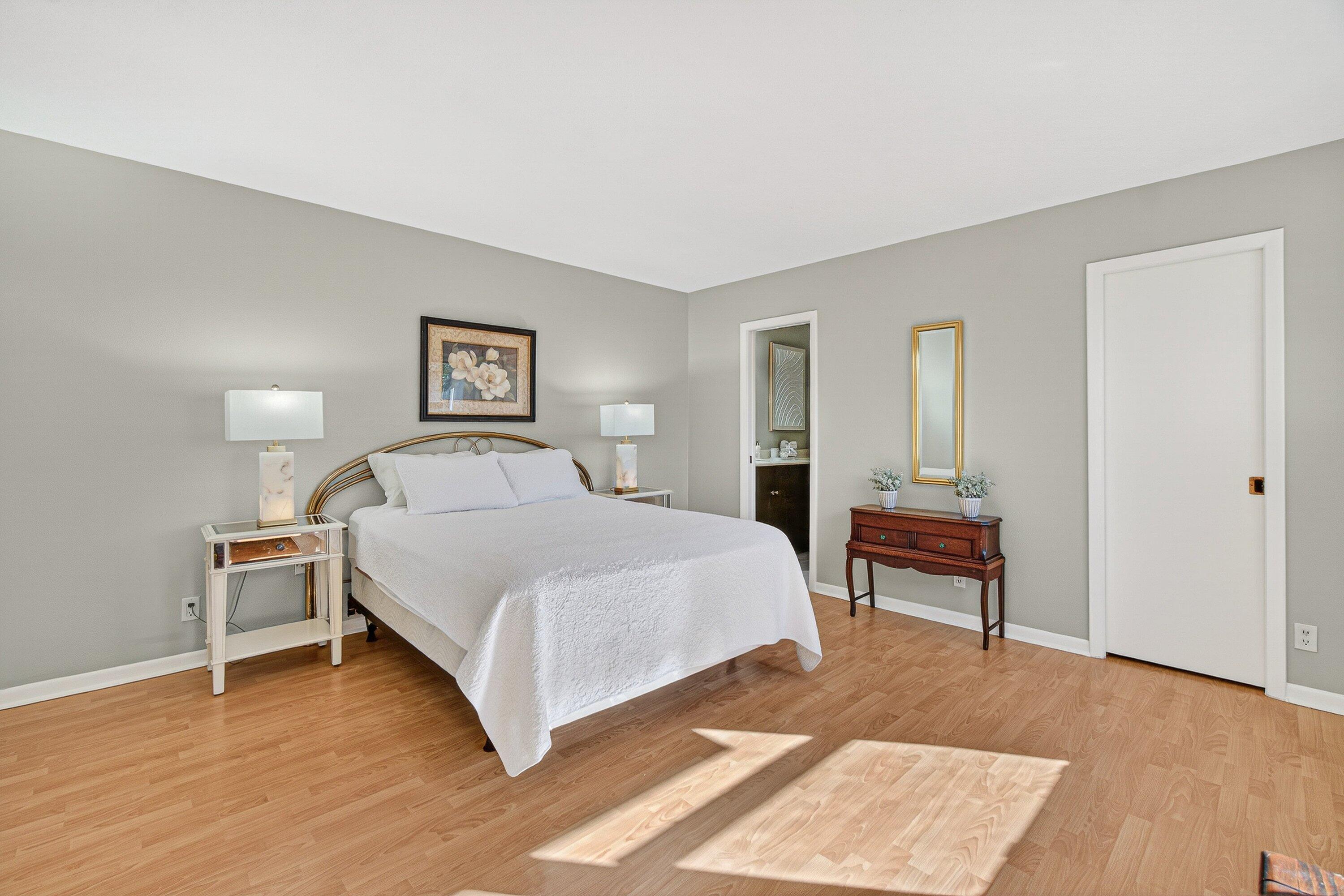 865 Northwest 29th Avenue, Unit D Delray Beach, FL 33445 - Photo 22 of 70 a bedroom with a bed table and a window