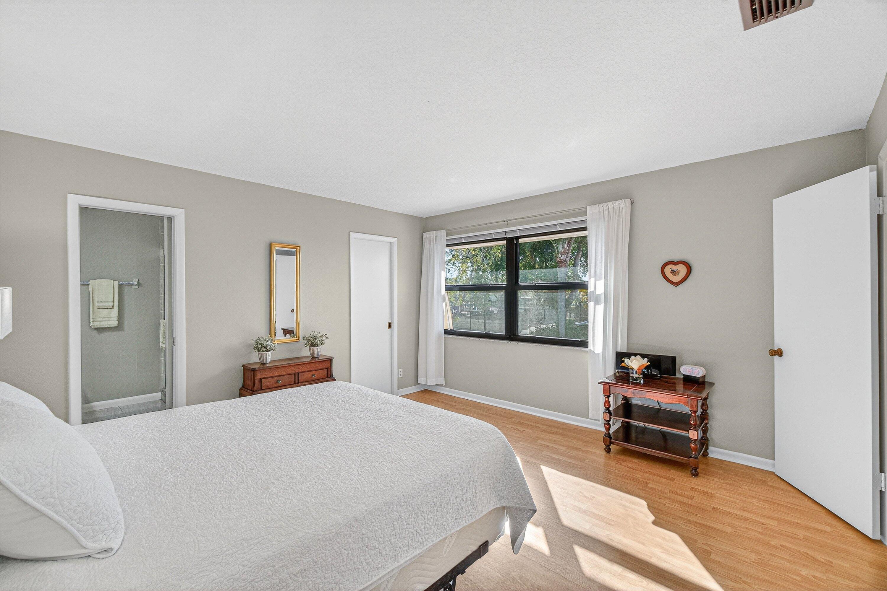 865 Northwest 29th Avenue, Unit D Delray Beach, FL 33445 - Photo 24 of 70 a bedroom with a bed and a window