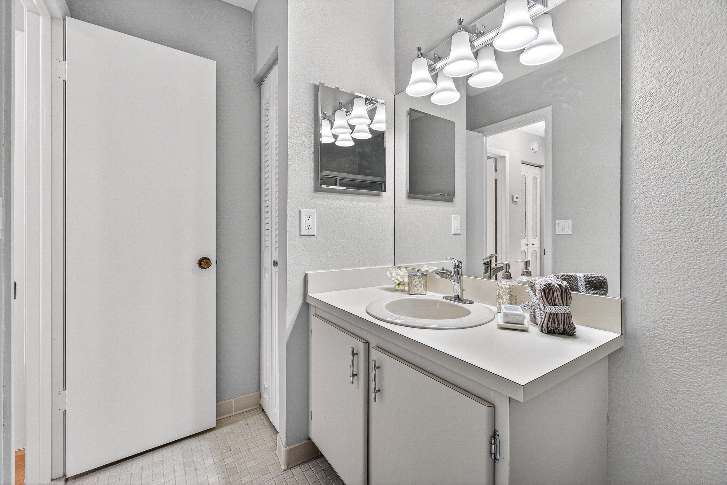 865 Northwest 29th Avenue, Unit D Delray Beach, FL 33445 - Photo 30 of 70 a bathroom with a sink vanity and a mirror