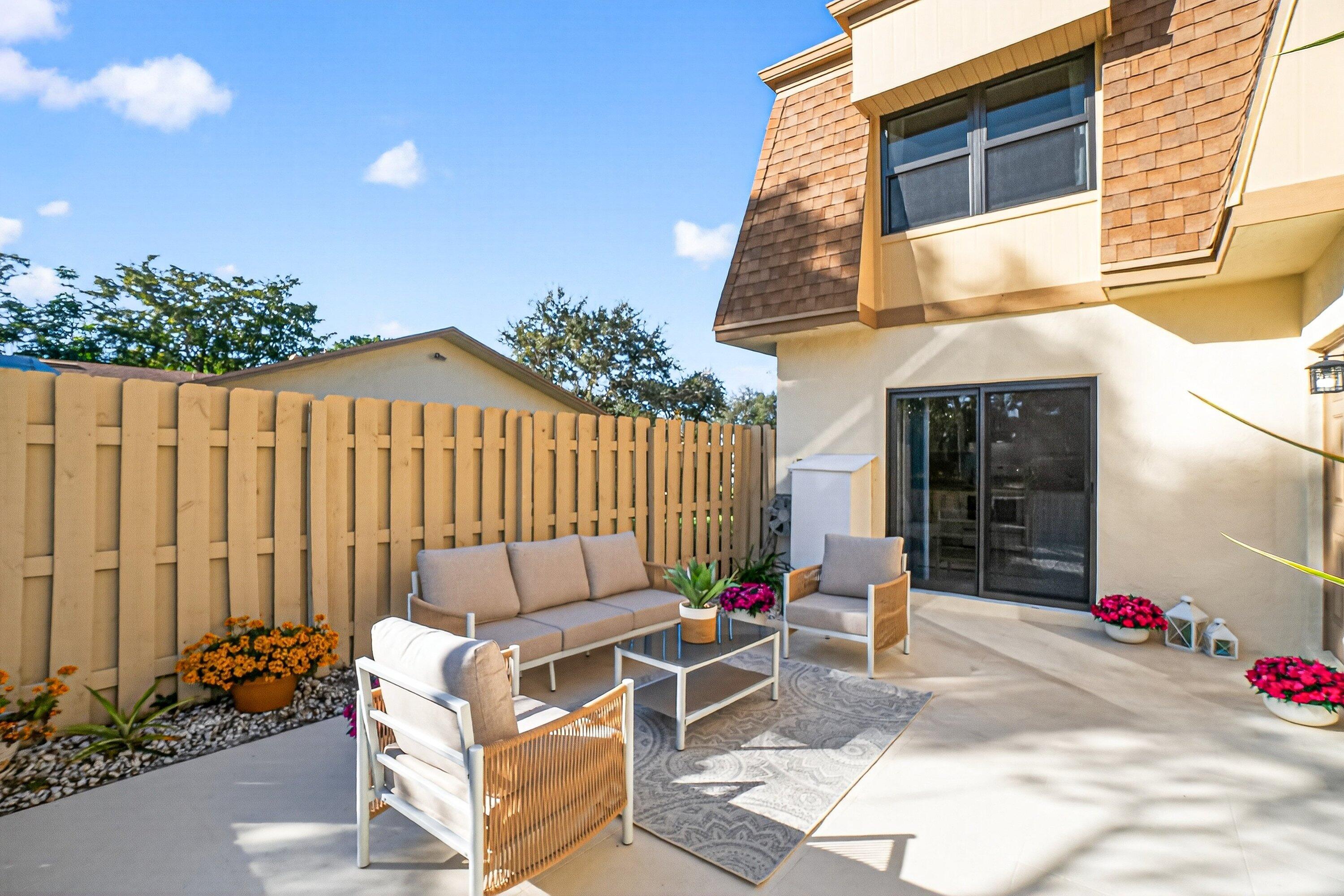 865 Northwest 29th Avenue, Unit D Delray Beach, FL 33445 - Photo 33 of 70 a building outdoor space with patio furniture and potted plants