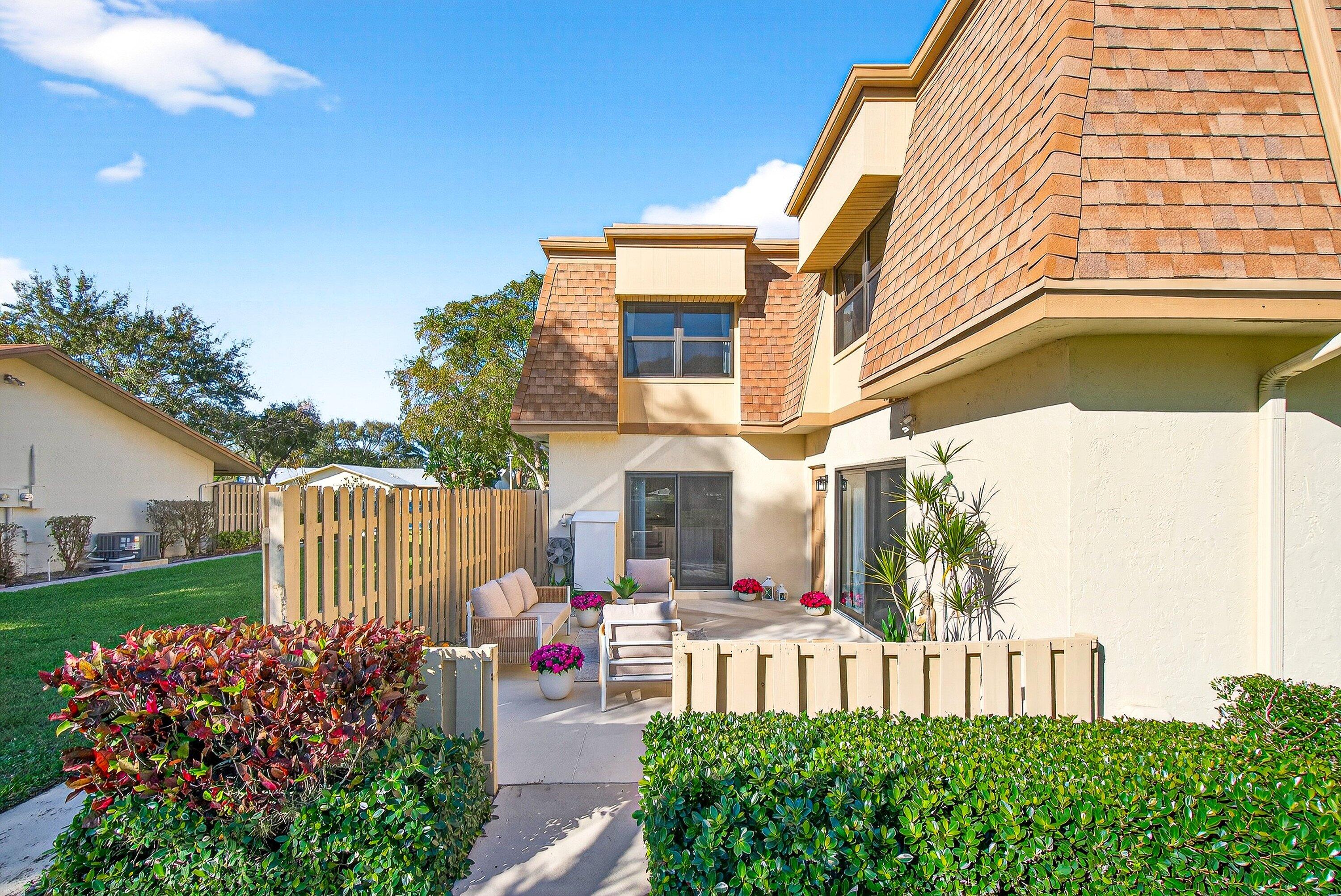 865 Northwest 29th Avenue, Unit D Delray Beach, FL 33445 - Photo 34 of 70 a front view of a house with garden