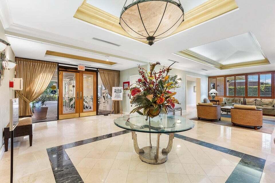 865 Northwest 29th Avenue, Unit D Delray Beach, FL 33445 - Photo 43 of 70 a living room with furniture and a chandelier