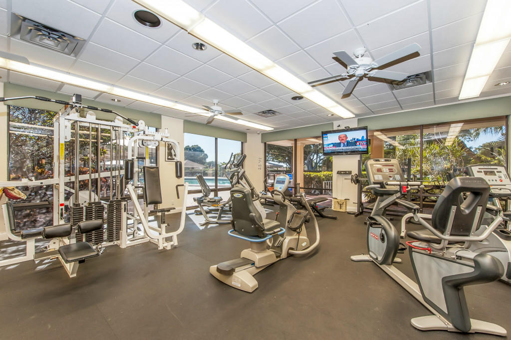 865 Northwest 29th Avenue, Unit D Delray Beach, FL 33445 - Photo 44 of 70 a room with gym equipment and large mirror