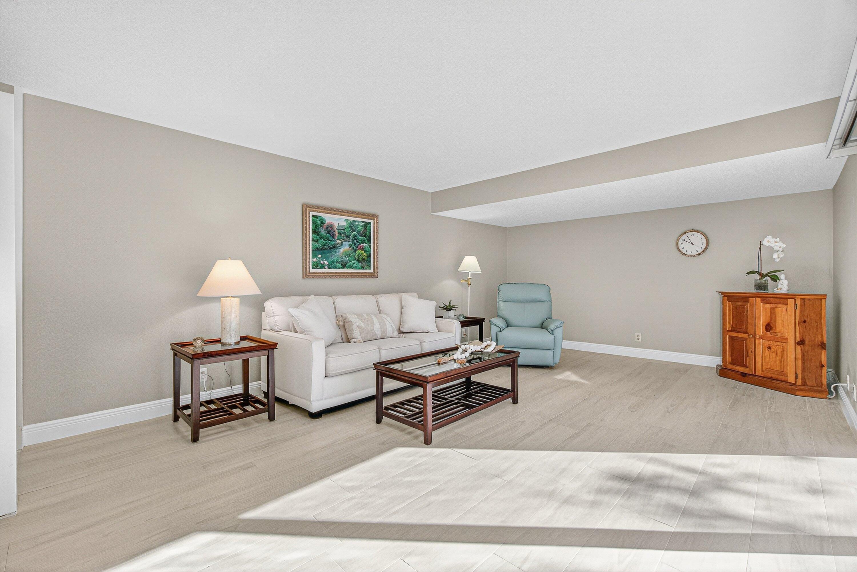 865 Northwest 29th Avenue, Unit D Delray Beach, FL 33445 - Photo 5 of 70 a living room with furniture and a lamp