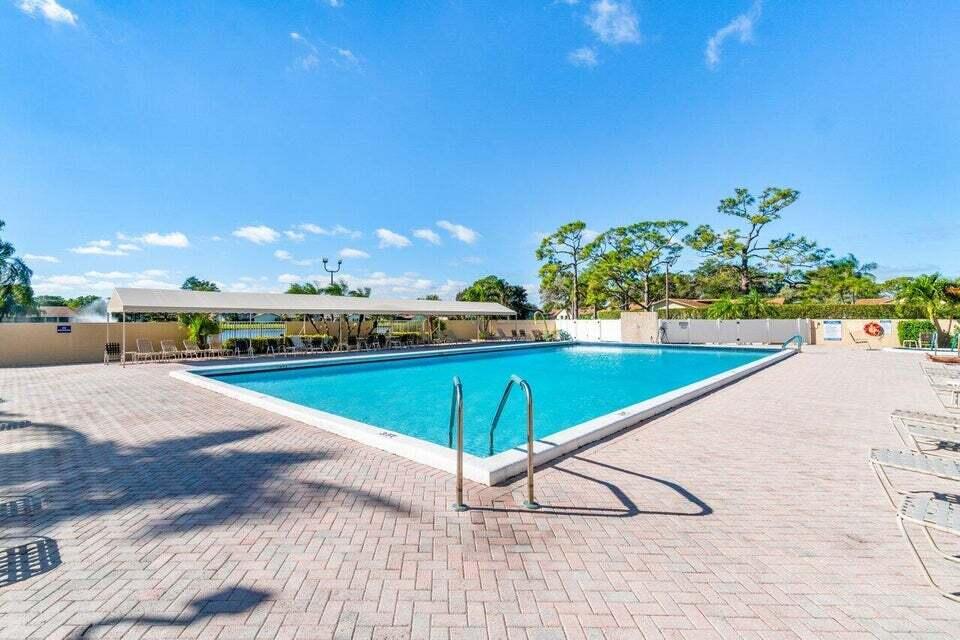 865 Northwest 29th Avenue, Unit D Delray Beach, FL 33445 - Photo 55 of 70 a view of a swimming pool and an outdoor space