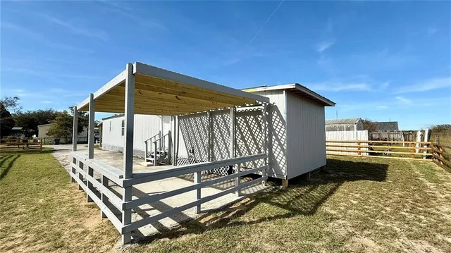 a view of a house with backyard and sitting area