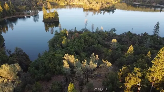 a view of a lake with a house and a mountain view