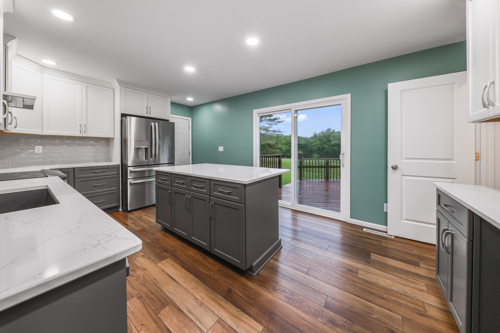 2433 East 2850th Road Marseilles, IL 61341 - Photo 6 of 20 a kitchen with stainless steel appliances kitchen island granite countertop a refrigerator a stove and a wooden floors
