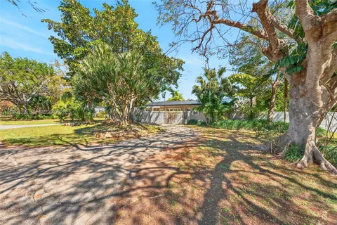 a view of a house with a yard and tree