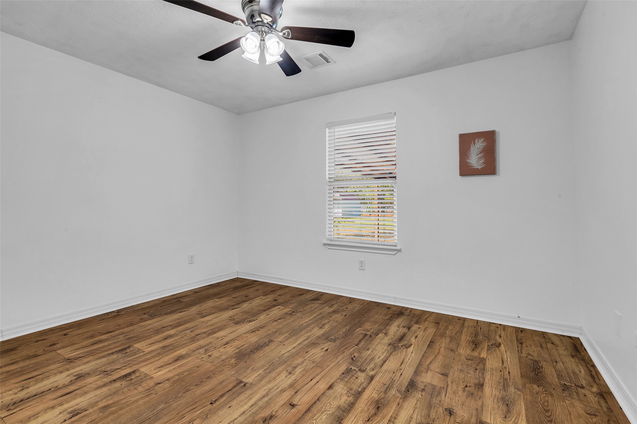 3862 Highline Oaks West Conroe, TX 77306 - Photo 14 of 23 wooden floor in an empty room with a window