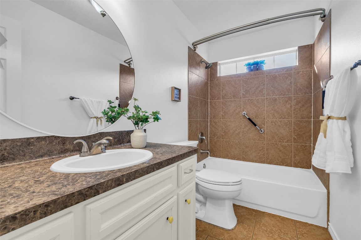 3862 Highline Oaks West Conroe, TX 77306 - Photo 15 of 23 a bathroom with a granite countertop sink toilet a mirror and shower
