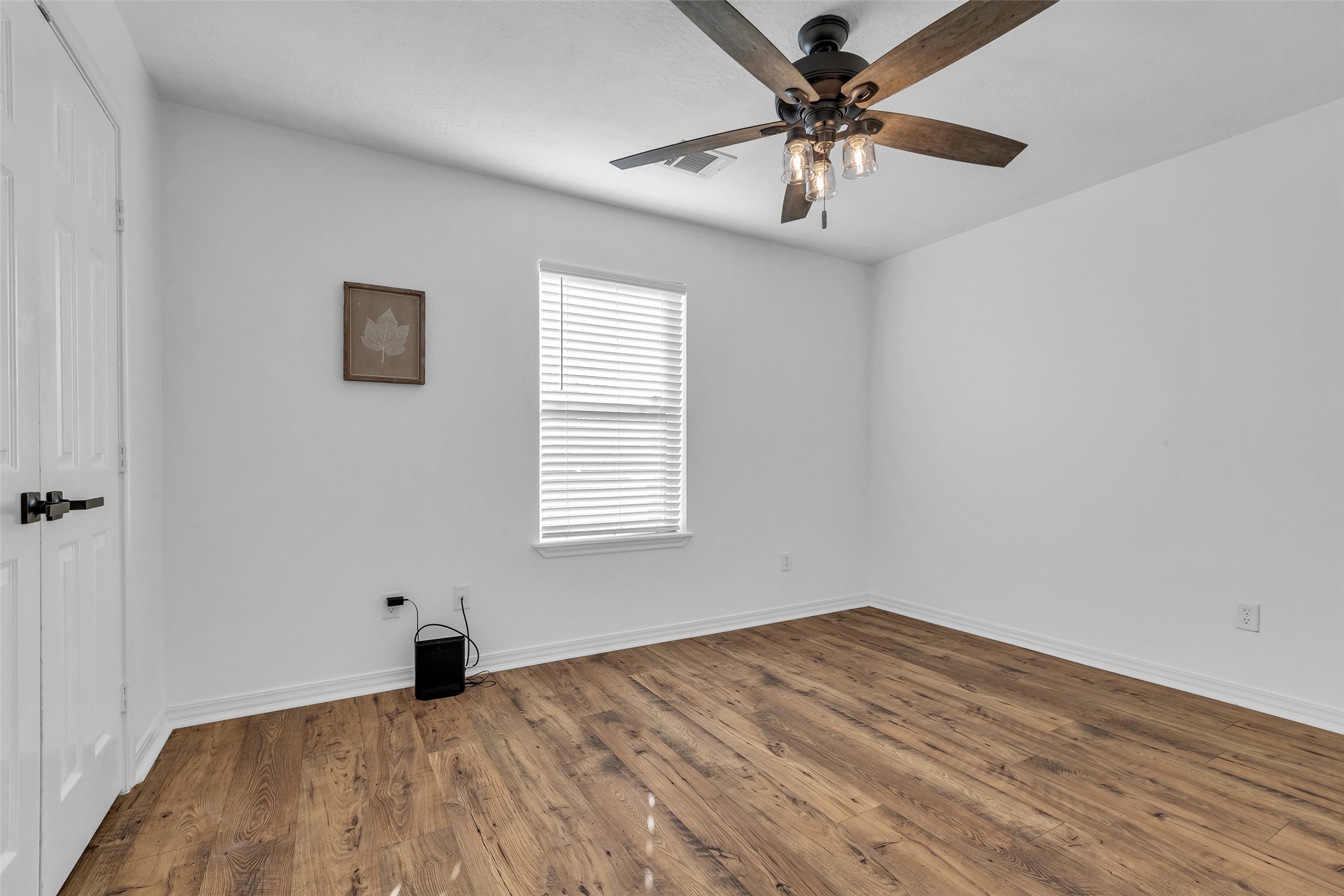 3862 Highline Oaks West Conroe, TX 77306 - Photo 16 of 23 wooden floor in an empty room with a window