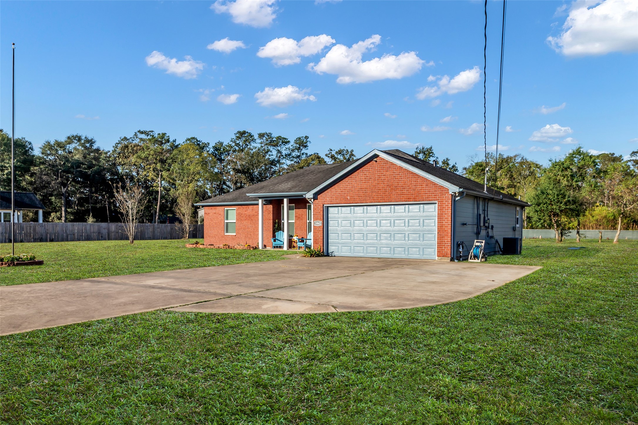 3862 Highline Oaks West Conroe, TX 77306 - Photo 2 of 23 a front view of a house with a yard and garage